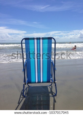 Blue beach chair at the seashore.