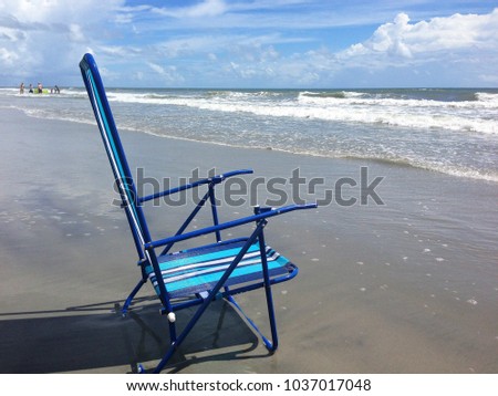 Blue beach chair at the seashore.