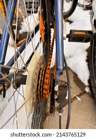 Blue Bike Has Been Outside All Winter And Got Broken. Rusty Bicycle Chain Hangs On Sprocket And Gear.