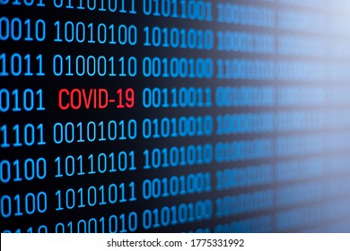 Blue binary code on computer screen with inscription COVID-19 written in red in the middle of the code. Symbol of coronavirus outbreak
