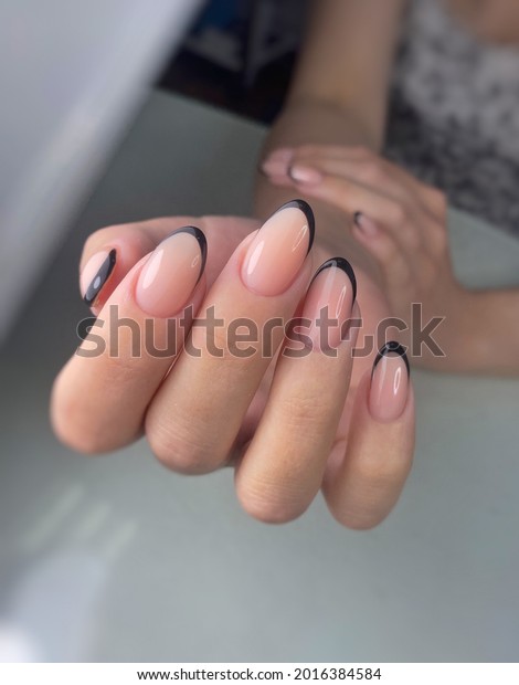 blue black French nails polishing nails with gel\
polish, manicure on hands, neat hands, beautiful nails on hands,\
beauty salon , nail bar