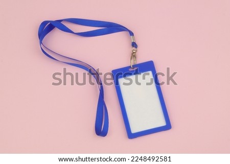 Blue blank badge with white space for text on pink background.