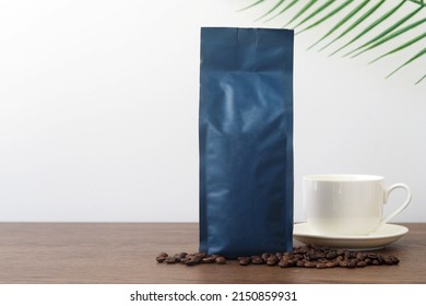 Blue Blank Coffee Bag On Wooden Table. Packaging Mockup With Empty Space For You Designs.