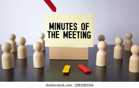 Blue Board With Text MINUTES OF THE MEETING On The Office Background.