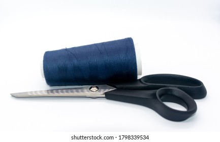 Blue bobbin thread and black scissors isolated on white background. Close up of a spool of blue sewing thread. Thread is a type of yarn but similarly used for sewing.  - Shutterstock ID 1798339534