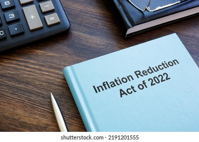 Blue book with The Inflation Reduction Act of 2022 near calculator and notebook. - Shutterstock ID 2191201555