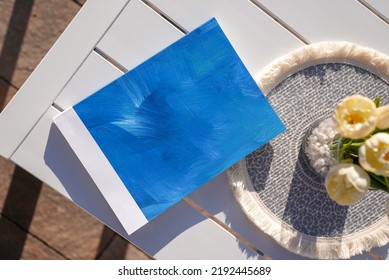 Blue Book On Metal Table In The Courtyard On The Garden Floor,shot From Above