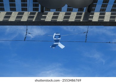 A blue bow tied for Blue November, the mobilization for the screening of male cancers - Powered by Shutterstock