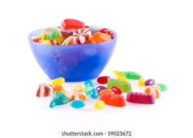 Blue Bowl With Different Kinds Of Colorful Candy Isolated On White.