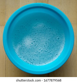 Blue Bowl With Soapy Water And Foam