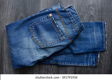 Blue Boyfriend  Jeans On Black Wooden Background. 