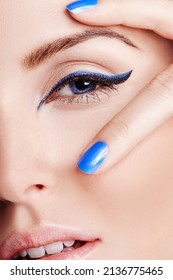 Blue Brings Out The Eyes. Close Up Of A Blue Eye With Blue Eyeliner With Two Fingers With Blue Nailpolish On.