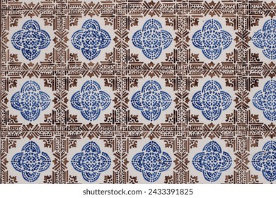 Blue and brown Portuguese ceramic tile pattern, azulejos. Beautiful shabby facade, wall decoration of old Lisbon building, Portugal. Decorative background, geometric floral ornaments, Moroccan style.