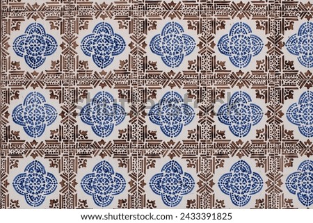 Blue and brown Portuguese ceramic tile pattern, azulejos. Beautiful shabby facade, wall decoration of old Lisbon building, Portugal. Decorative background, geometric floral ornaments, Moroccan style.