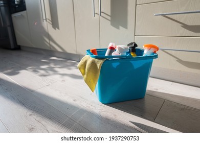 A Blue Bucket Of Cleaning Products In The Kitchen. A Set Of Detergents And A Rag For Home Cleaning On The Floor In The Apartment. No People.