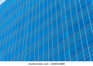 Blue Building Exterior With Reflective Glass Facade In Downtown Austin Texas. Modern Houses Or Commercial Office Real Estate Property Concept Viewed In The City.