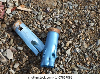 Blue Bullet Shells, Spent, Laying On The Ground.