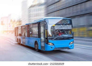 Blue bus moving on the road in city in early morning - Powered by Shutterstock