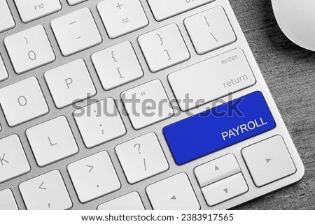 Blue button with word Payroll on keyboard, top view