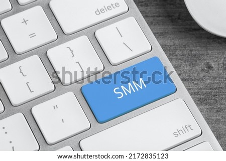 Blue button with word SMM on computed keyboard, closeup