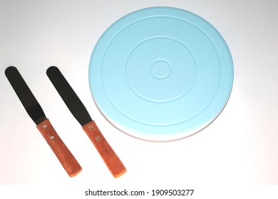 Blue Cake Turntable With Wooden Handle Spatula In White Background