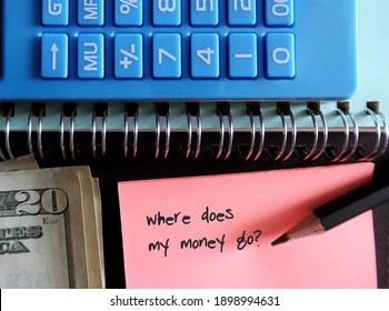 Blue calculator, cash money, pencil, pink note with text written WHERE DOES MY MONEY GO?, concept of find out spending leaks to fix them and boost saving