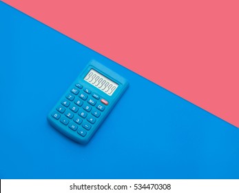 Blue Calculator On Blue And Pink Background;minimal Flat Lay Style 