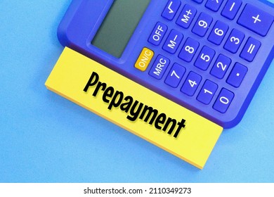blue calculator and yellow paper with the word prepayment
