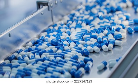 Blue Capsules are Moving on Conveyor at Modern Pharmaceutical Factory. Tablet and Capsule Manufacturing Process. Close-up Shot of Medical Drug Production Line. - Shutterstock ID 2229147123