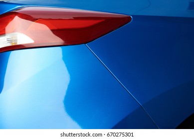 Blue Car Backlight  Close-up. Shiny New Polished Blue Car Paint