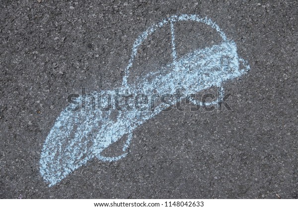 a blue car\
drawn with chalk on the\
street\
