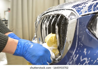 Blue Car Handwash With Yellow Sponge In Blue Gloves