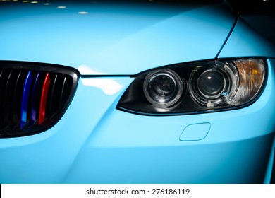 Blue car with headlight, grille and bumper