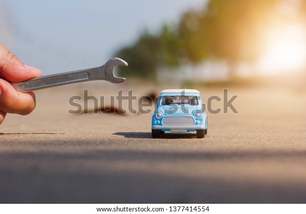 blue car model with equipment for fixing, car\
insurance concep