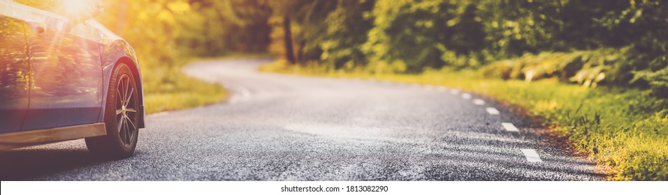 blue car on asphalt road in summer