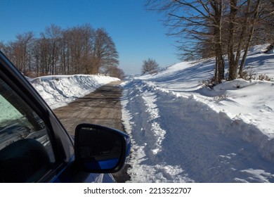 Blue Car On A Mountain Path Snow