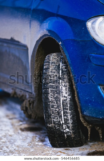 Blue car on the winter\
background snow.