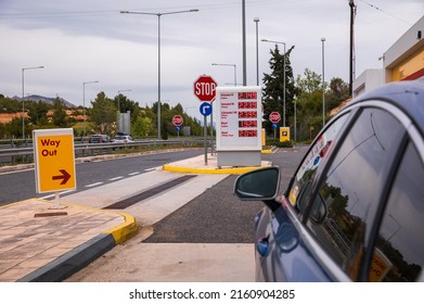 Blue car refuel at the Moreas Motorway-A7 on the background of a sign with prices on May 1, 2022 to ATHENS direction, Peloponnese, GREECE.