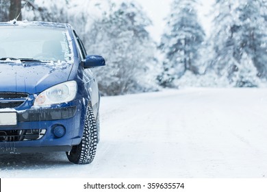 Blue car without a trade brand on winter road.