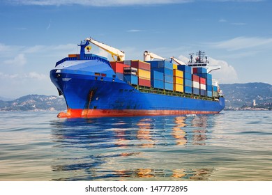 Blue Cargo Container Ship Anchored In Harbor