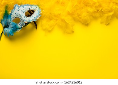 Blue Carnival Mask With Yellow Feather Boa And Copy Space 