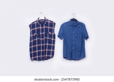 Blue casual denim shirt  with plaid on clothes rack on white background  - Powered by Shutterstock