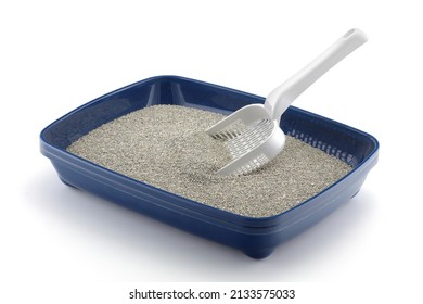 Blue cat litter tray isolated on white with grey litter and a scoop - Shutterstock ID 2133575033