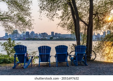 Blue Chairs Along The Coast In The Jean-Drapeau Park In Sunset Time. Saint Helens Island. Montreal, Quebec, Canada.