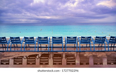 Blue chairs along the Promenade des Anglais on the Mediterranean Sea at Nice, France along the French Riviera. - Shutterstock ID 1727702296
