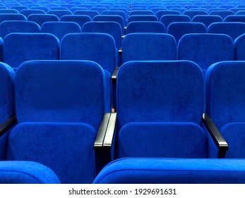 Blue chairs in an empty concert hall. Empty rows in the cinema.