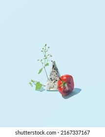 Blue Chees Slice And Tomato Cut, Creative Natural  Food Arrangement, Pastel Blue Background. 