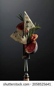 Blue Cheese With Figs, Walnuts, And Rosemary On A Fork.