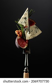 Blue Cheese With Figs, Walnuts, And Rosemary On A Fork.