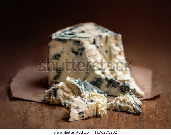 Blue cheese Gorgonzola on a rustic wooden\
background. Mold cheese with\
copyspace